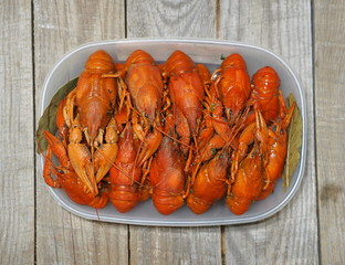 Red boiled crayfish on a wooden ancient background.