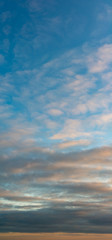 Fantastic clouds at sunrise, vertical panorama