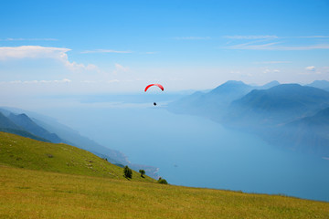 Monte Baldo mountain italy, paraglider floating over lake garda.