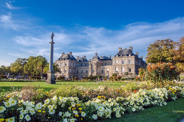 Fototapeta na wymiar Luxembourg Palace And Garden at day with blue sky and flowers, Paris, France