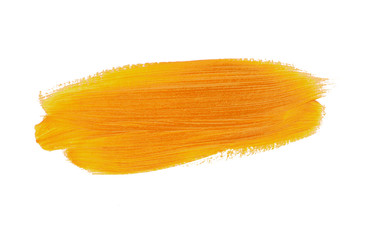 A smear of yellow paint. Bright acrylic paint. Brush stroke texture isolated on white