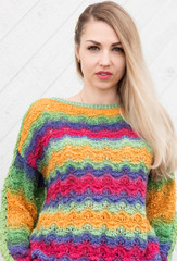 Young woman posing in hand-knitted sweater, knitted clothes