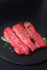 Food concept organic raw meat filet beef steak on black slate stone background