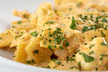 Traditional italian pasta. Fresh pappardelle pasta with porcini mushrooms. Traditional italian pasta cooked in italian style and spices. Parmesan and mozzarella cheese sauce dressing. Restaurant table