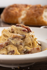Traditional italian pasta. Carbonara pasta. Spaghetti with pancetta, egg, parmesan cheese and cream sauce. Traditional italian cuisine. Dish of Spaghetti alla Carbonara, typical italian recipe