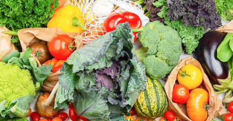 Eco shopping in recyclable packaging, top view of grocery colorful vegetables background, selective focus
