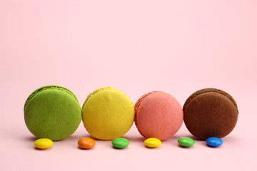 Colored macaroons or macarons on a pink background