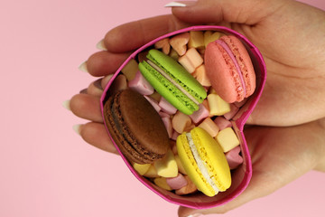 Colored macaroons or macarons, marshmallows-hearts in a box. Gift of lovers