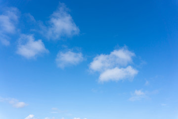 Naklejka na ściany i meble Beautiful form of white fluffy clouds on vivid blue sky in a suny day
