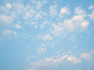 puffy fluffy clouds in spring evening with blue sky horizontal , abstract nature background