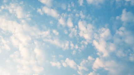 puffy fluffy clouds in spring evening with blue sky horizontal , abstract nature background