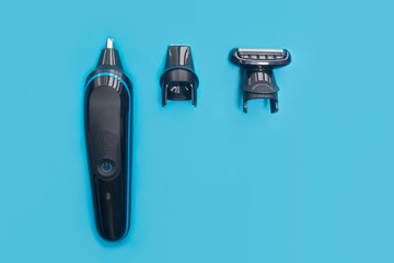 Men still life, flat lay. Composition, set for shaving. Electric razor trimmer with different nozzles for cutting mustache, beard and nose hair. Top view. Kit for male hairstyle. Home barbershop.