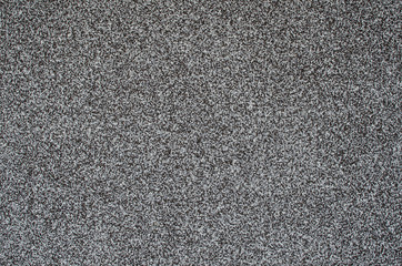 Gray background, wall with black, white and gray grains. Monochrome abstract background. Gray granite texture. Wall background, pattern. Wall decoration. Wall banner, grunge.