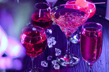 Cocktail drinks with ice in club lights