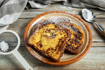 Slices of french toasts sprinkled with icing sugar