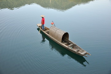 fishman and the boat floating in the lake