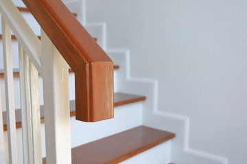 hardwood handrail banister and white steel balustrade on brown wooden stair interior decorated modern style of residential house