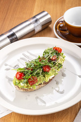 Crispy bruschetta with avocado. Useful Diet Toasts. Bruschetta with Avocado, Salmon and Cherry Tomatoes. Sandwiches with black rye bread and avocado mousse with spices