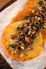 Potato pancakes with sour cream, herbs and garlic. Potato pancakes fried in butter. Potato pancake 
