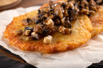 Potato pancakes with sour cream, herbs and garlic. Potato pancakes fried in butter. Potato pancake 