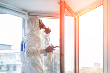 Man wearing protective biological suit and gas-mask due to mers coronavirus global pandemic warning...