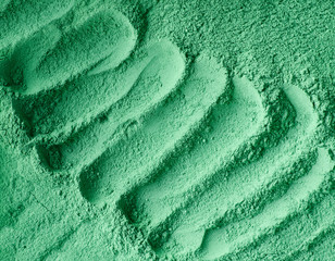 Green cosmetic clay powder (facial mask, face cream, body wrap) texture close up, selective focus....