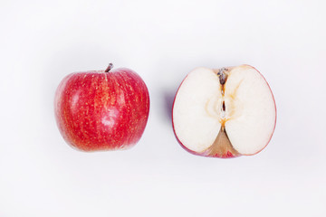 whole and sliced apple on a white background
