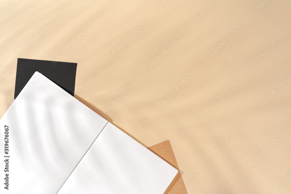 Poster Open blank notepad with copy space on beige background,  top view