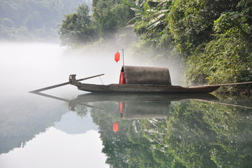 wooden boat over the mist water