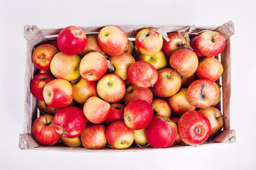 crate of red apples top view on a white background