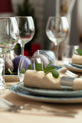 Table setting set with candles and plant branches