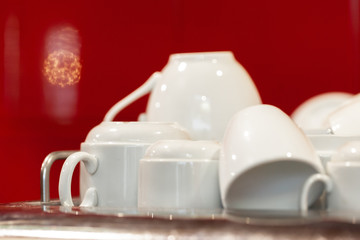 White ceramic cups on the top of professional coffee machine