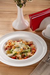 Delicious fresh salad. Shrimp salad, lettuce, arugula, olive oil, cheese, parmesan. fresh healthy avocado and shrimps salad. Close up view on Salad. Healthy, diet tasty summer dish