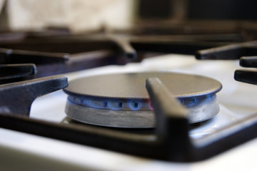 Fototapeta na wymiar Kitchen gas stove with low burning propane gas.