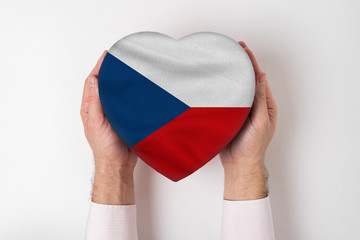 Flag of Czech Republic on a heart shaped box in a male hands. White background