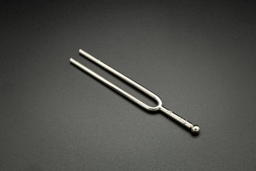 A tuning fork 440 Hz on a black background