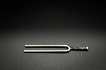 A tuning fork 440 Hz on a black background