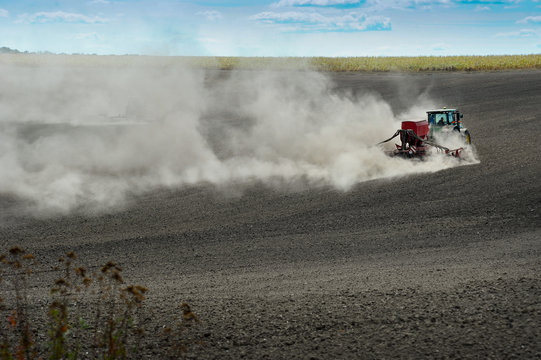 Terebovla region, Ternopil ,Ukraine - 14 September, 2019 : sowing work on the plowed ground, a plume of dust behind tactor