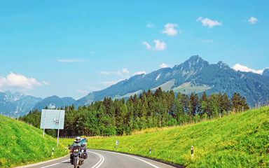 Road with motorcycle at Prealps mountains in Gruyere district, Canton Fribourg in Switzerland
