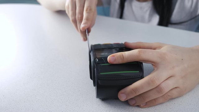 Payment by credit card, purchase and sale of lifestyle goods and services. Credit card in the store. girl pays on the card reader online shopping concept