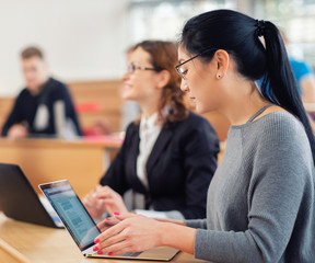 Lecturer and multinational group of students in an auditorium