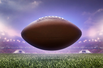photo american football ball on stadium background.