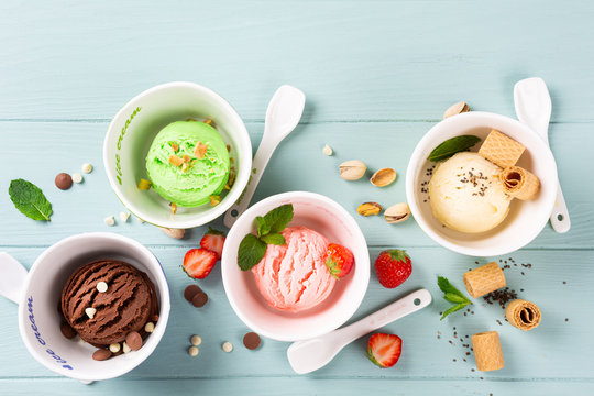 Homemade assorted ice cream on light blue wooden background. Healthy summer food concept. Top view, copy space.