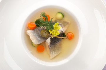 Delicious fish soup in bowl on table, close up