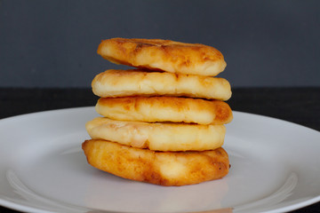 plate with pancakes and berries on a black background. the concept of a delicious Breakfast and menu. space for text. plate with homemade pancakes and cheesecakes.