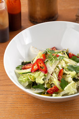 Spicy asian salad. Thai salad with greens, vegetables. Asian salad with chili, corn, cucumber, carrot, onion, soy, popular in the country Thailand. Indo-chinese cuisine hot dish with vegetables and ch