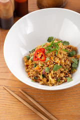 Thai food fried rice with egg. Asian cuisine-Homemade egg fried rice served with vegetables. Fried rice with vegetables, pepper, carrot, parsley, onion, chilli. Indo-chinese cuisine hot dish 