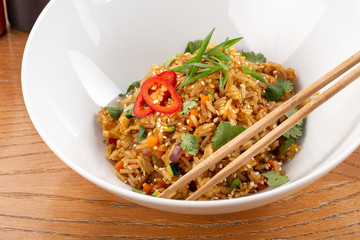 Thai food fried rice with egg. Asian cuisine-Homemade egg fried rice served with vegetables. Fried rice with vegetables, pepper, carrot, parsley, onion, chilli. Indo-chinese cuisine hot dish 