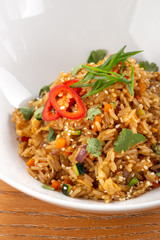 Thai food fried rice with egg. Asian cuisine-Homemade egg fried rice served with vegetables. Fried rice with vegetables, pepper, carrot, parsley, onion, chilli. Indo-chinese cuisine hot dish 