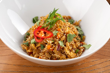 Thai food fried rice with egg. Asian cuisine-Homemade egg fried rice served with vegetables. Fried rice with vegetables, pepper, carrot, parsley, onion, chilli. Indo-chinese cuisine hot dish 
